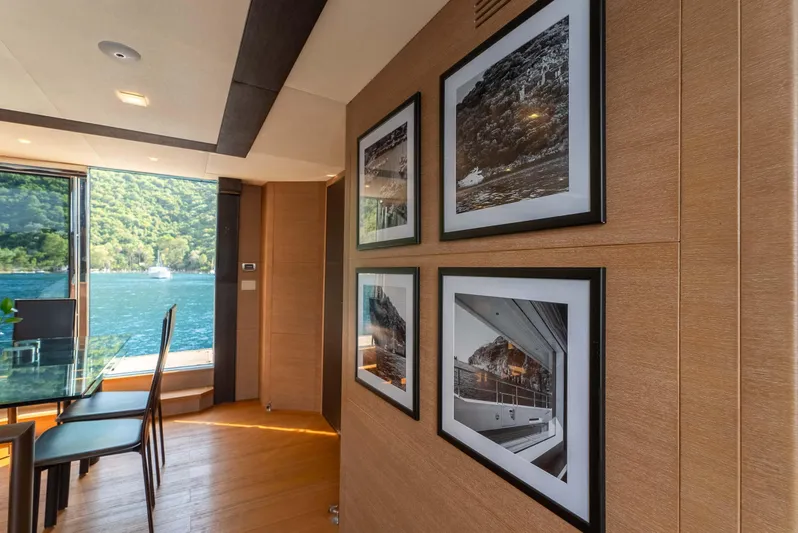  Yacht Photos Pics Luxurious interior of 2016 Monte Carlo Yachts MCY 86 with scenic water view and framed artwork.