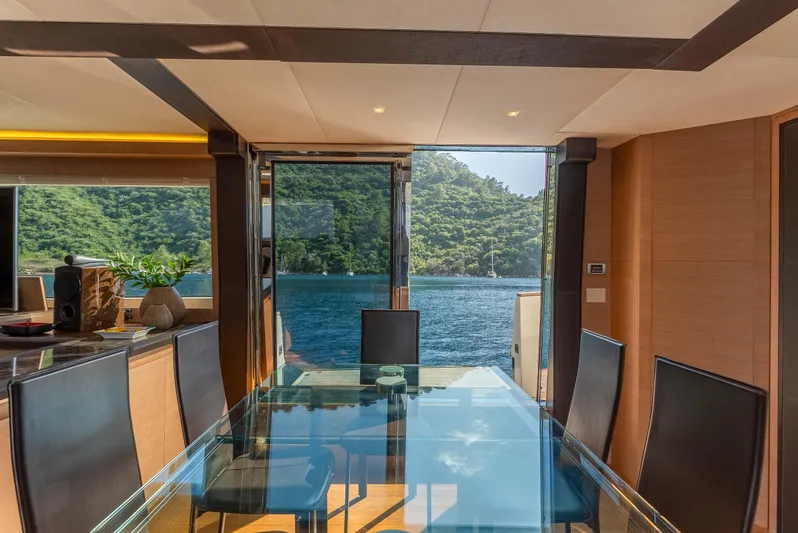  Yacht Photos Pics Luxurious Monte Carlo Yachts MCY 86 interior with glass table, ocean view, and elegant design.