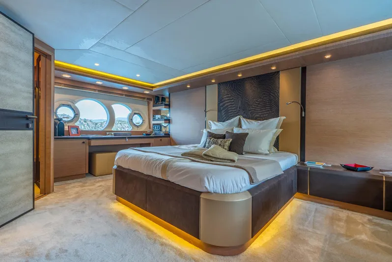  Yacht Photos Pics Luxurious bedroom interior of 2016 Monte Carlo Yachts MCY 86 with elegant decor and ambient lighting.