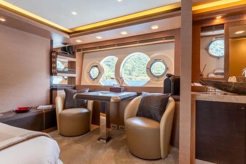  Yacht Photos Pics Luxurious interior of 2016 Monte Carlo Yachts MCY 86 with elegant seating and porthole windows.