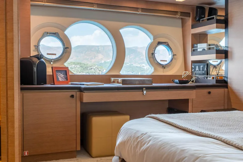  Yacht Photos Pics Luxurious interior of 2016 Monte Carlo Yachts MCY 86 with porthole windows and elegant furnishings.