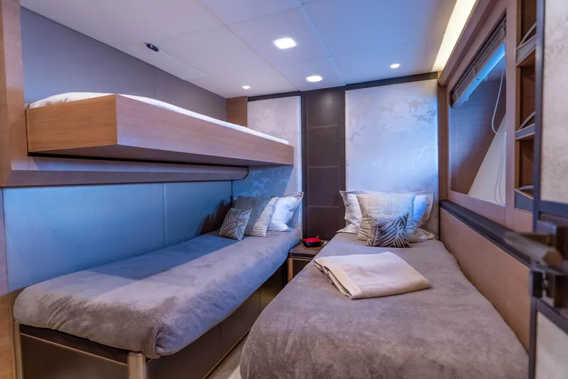  Yacht Photos Pics Luxurious cabin interior of 2016 Monte Carlo Yachts MCY 86 with twin beds and modern decor.