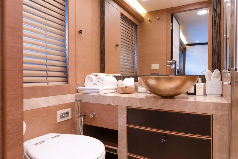  Yacht Photos Pics Luxurious bathroom in 2016 Monte Carlo Yachts MCY 86 with elegant fixtures and modern design.