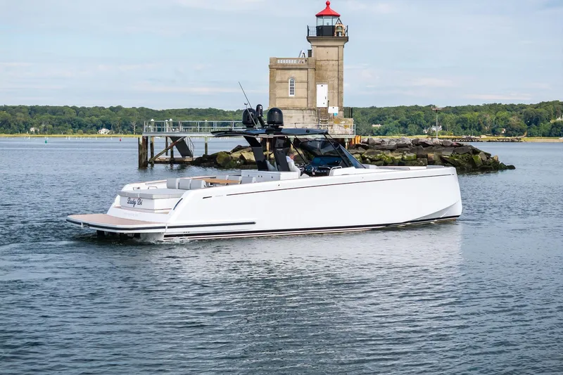 Lady Di Yacht Photos Pics 2024 Pardo Yachts 43 cruising near a lighthouse on a calm day.