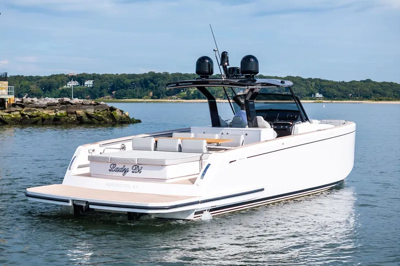 Lady Di Yacht Photos Pics 2024 Pardo Yachts 43 cruising on calm waters near a rocky shoreline.