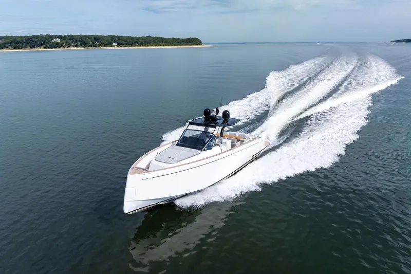 Lady Di Yacht Photos Pics 2024 Pardo Yachts 43 cruising on calm waters near a forested shoreline.