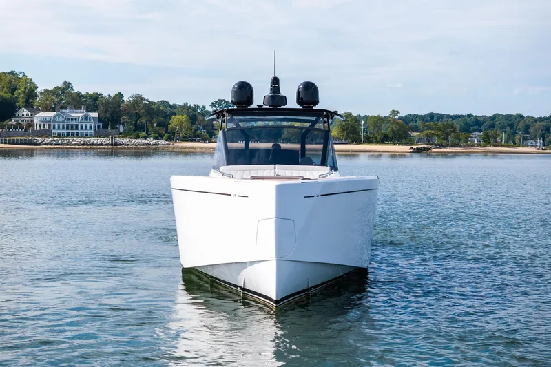 Lady Di Yacht Photos Pics 2024 Pardo Yachts 43 on calm water near a scenic shoreline.