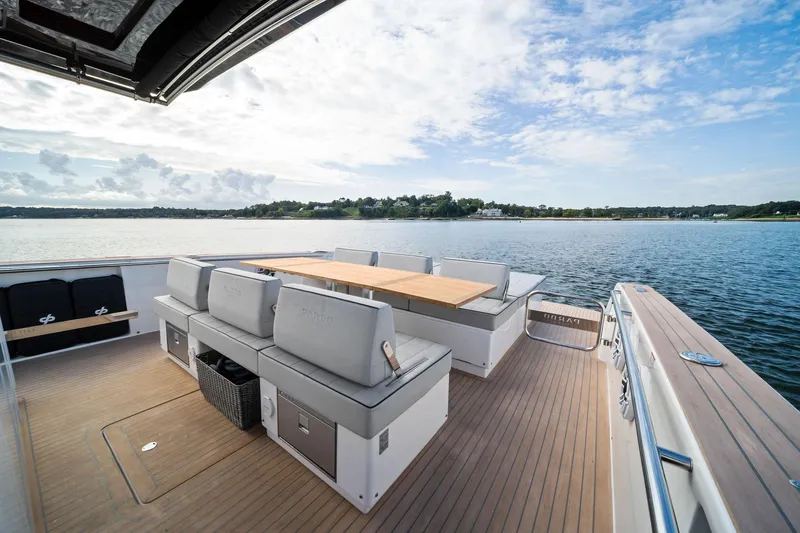 Lady Di Yacht Photos Pics 2024 Pardo Yachts 43 deck with seating and table, overlooking serene waters.
