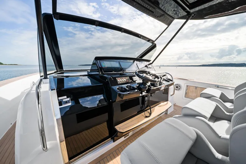 Lady Di Yacht Photos Pics 2024 Pardo Yachts 43 helm with modern controls and luxurious seating, overlooking serene waters.