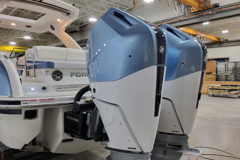  Yacht Photos Pics 2026 Formula 310 Bowrider OB with dual outboard engines in a showroom setting.