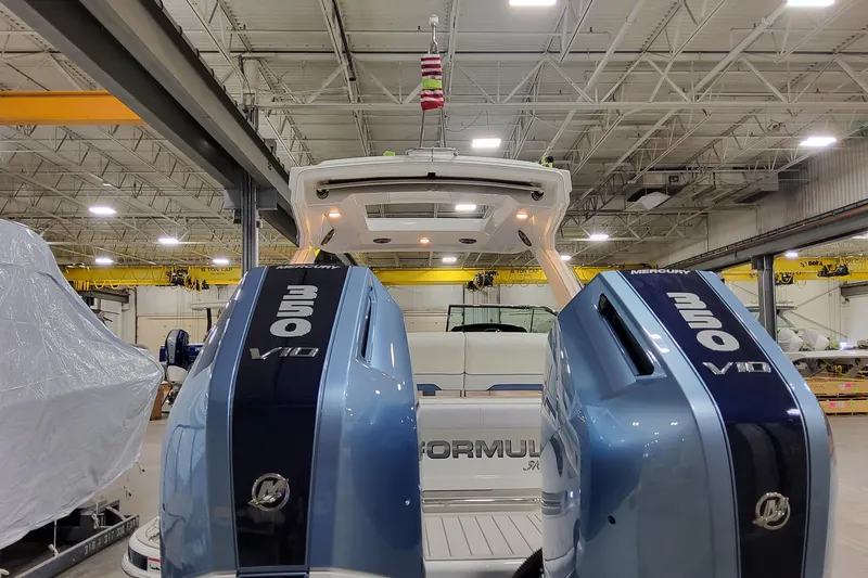  Yacht Photos Pics 2026 Formula 310 Bowrider OB with dual Mercury 350 V10 engines in a warehouse.