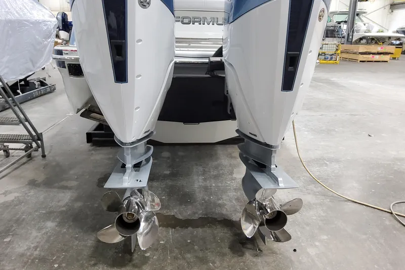  Yacht Photos Pics 2026 Formula 310 Bowrider OB with dual outboard engines in a workshop setting.