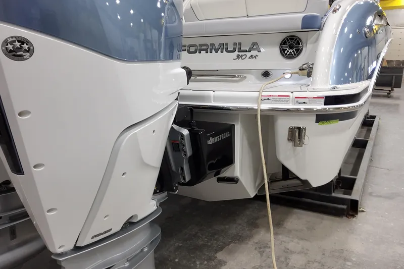  Yacht Photos Pics 2026 Formula 310 Bowrider OB boat with outboard motor in a showroom.