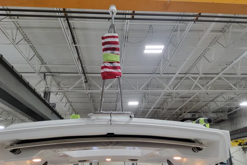  Yacht Photos Pics 2026 Formula 310 Bowrider OB in a warehouse, featuring a hoisting mechanism.