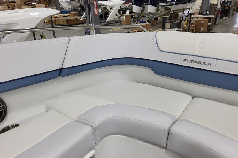 Yacht Photos Pics 2026 Formula 310 Bowrider OB interior with white and blue seating in a showroom.
