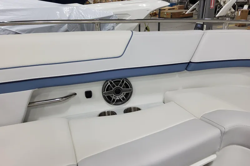  Yacht Photos Pics 2026 Formula 310 Bowrider OB interior with white and blue seating, speaker, and cup holders.