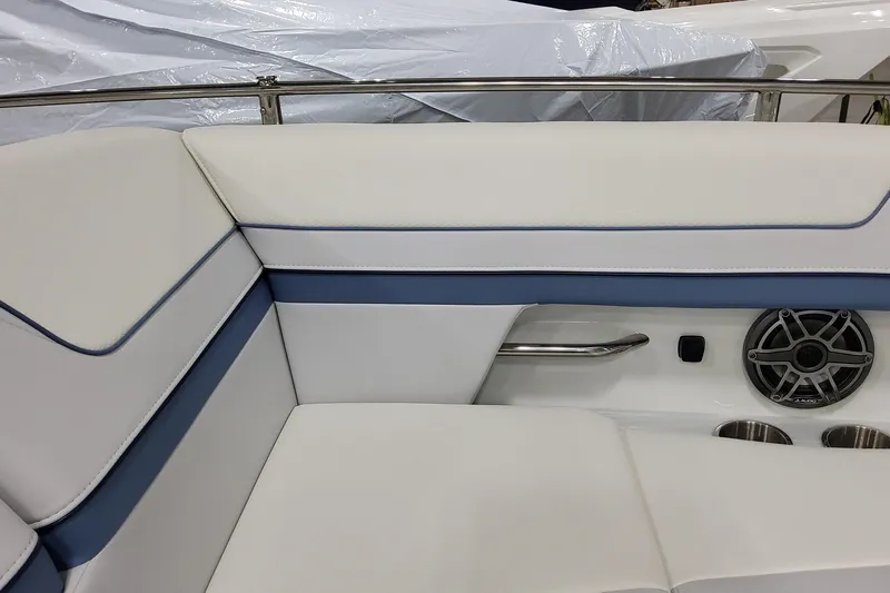  Yacht Photos Pics 2026 Formula 310 Bowrider OB interior with white and blue seating, speaker, and cup holders.