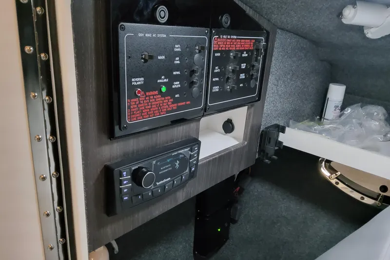  Yacht Photos Pics Control panel inside 2026 Formula 310 Bowrider OB boat, featuring electrical systems and stereo controls.