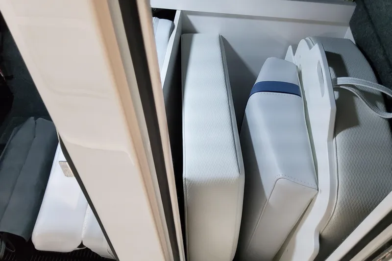  Yacht Photos Pics 2026 Formula 310 Bowrider OB storage compartment with neatly arranged white cushions.