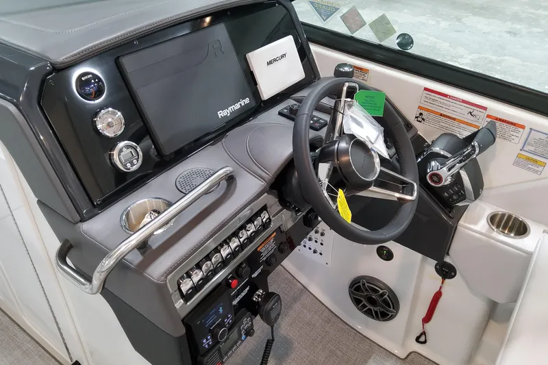  Yacht Photos Pics 2026 Formula 310 Bowrider OB helm with Raymarine display and Mercury controls.