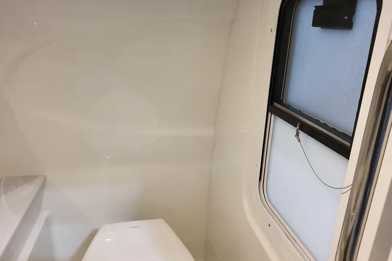  Yacht Photos Pics Interior of 2026 Formula 310 Bowrider OB boat, featuring a compact bathroom with window.