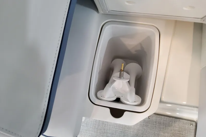  Yacht Photos Pics 2026 Formula 310 Bowrider OB boat storage compartment with integrated cup holder.