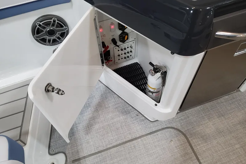  Yacht Photos Pics 2026 Formula 310 Bowrider OB interior storage with open cabinet and fire extinguisher.