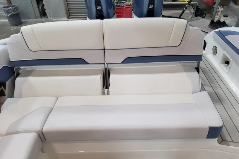  Yacht Photos Pics 2026 Formula 310 Bowrider OB boat interior seating with white and blue upholstery.