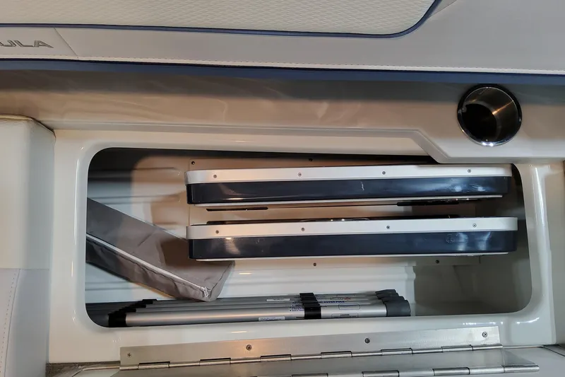  Yacht Photos Pics Storage compartment in 2026 Formula 310 Bowrider OB boat, featuring organized equipment.