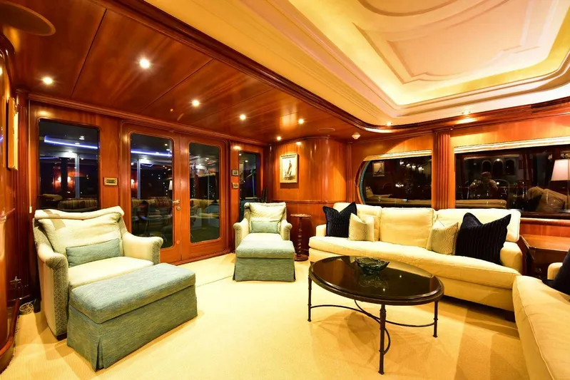 Waterford (name Reserved) Yacht Photos Pics Luxurious yacht interior with elegant seating, wooden paneling, and ambient lighting.