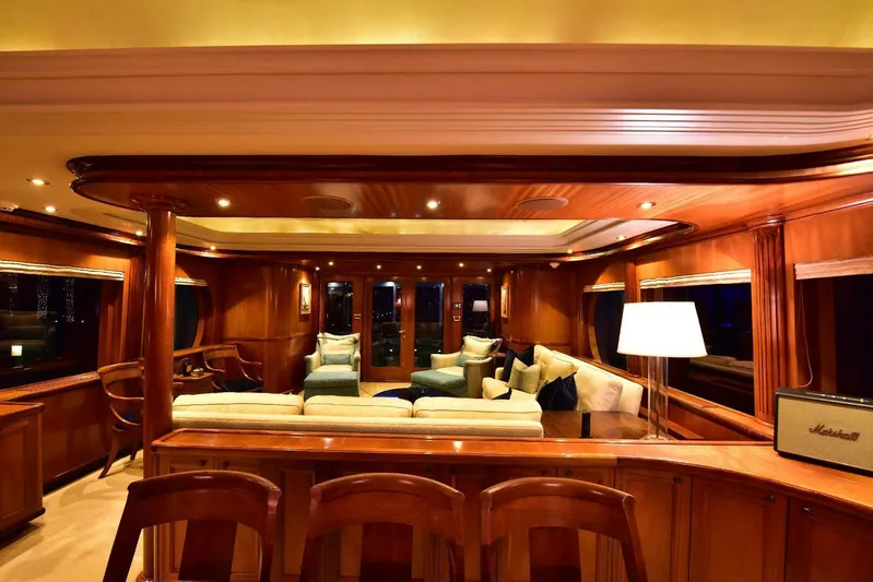 Waterford (name Reserved) Yacht Photos Pics Luxurious yacht interior with wooden decor, plush seating, and ambient lighting. Sovereign 2016 model.