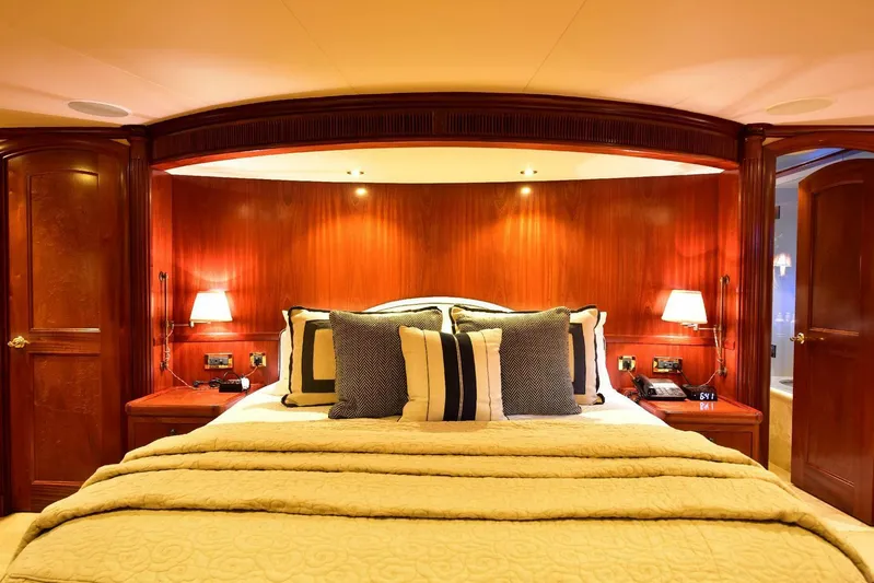 Waterford (name Reserved) Yacht Photos Pics Luxurious bedroom in 2016 Sovereign Pilothouse yacht with elegant wood paneling and plush bedding.