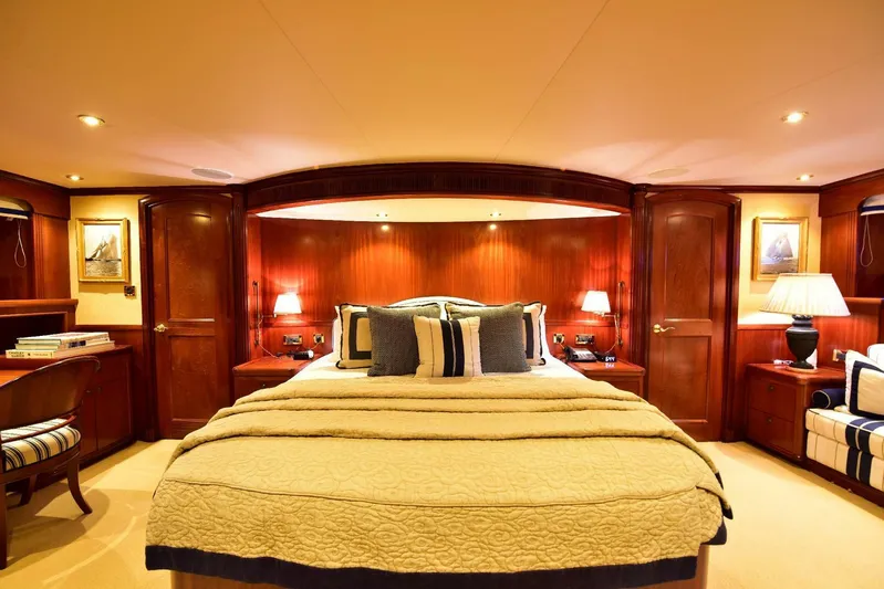 Waterford (name Reserved) Yacht Photos Pics Luxurious yacht bedroom with elegant wood paneling and ambient lighting, Sovereign 2016 model.