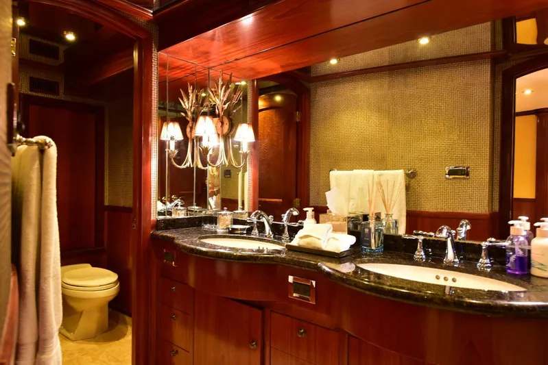 Waterford (name Reserved) Yacht Photos Pics Luxurious yacht bathroom with double sinks, elegant lighting, and rich wood accents, 2016 Sovereign model.