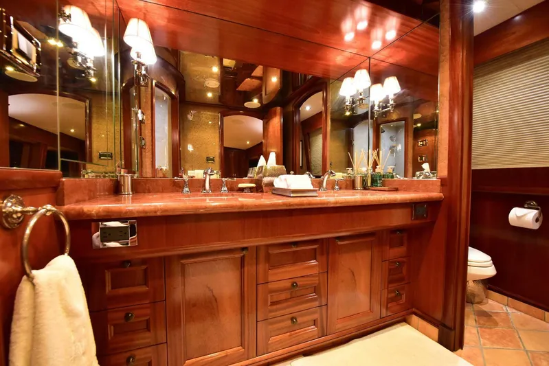 Waterford (name Reserved) Yacht Photos Pics Luxurious wooden bathroom interior on 2016 Sovereign Pilothouse yacht, featuring elegant fixtures and mirrors.