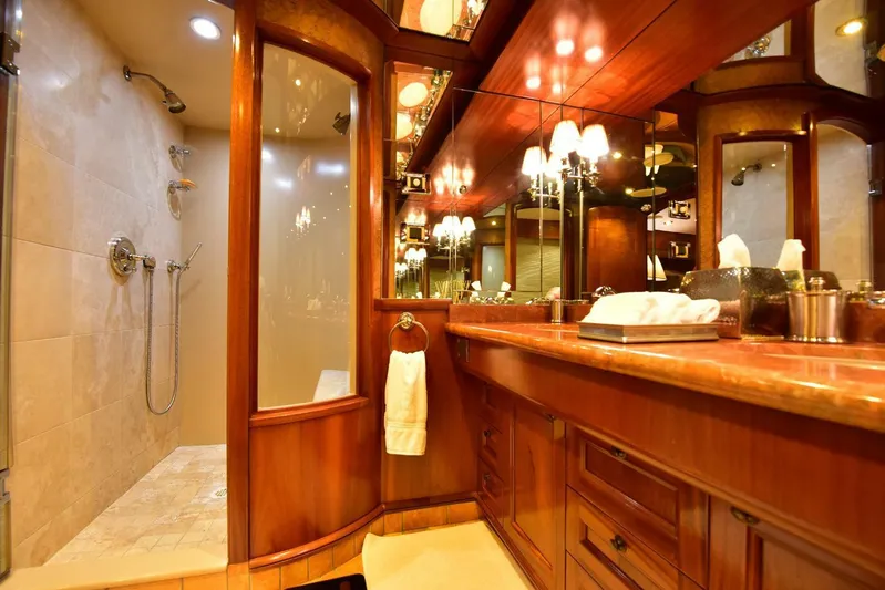 Waterford (name Reserved) Yacht Photos Pics Luxurious yacht bathroom with wooden cabinetry, glass shower, and elegant lighting, 2016 Sovereign model.