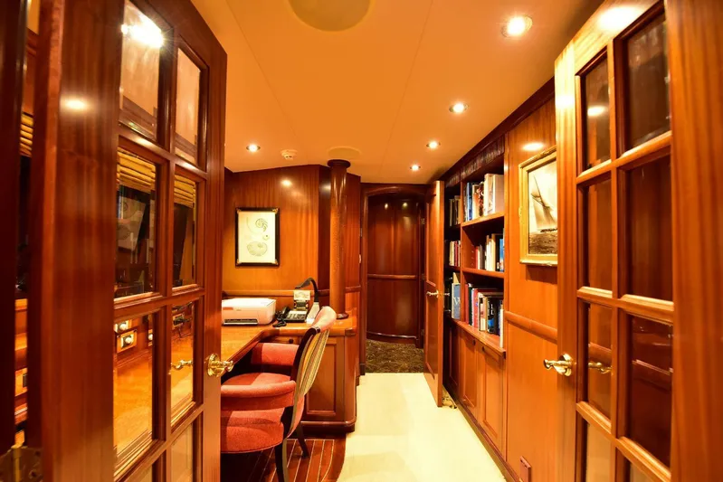 Waterford (name Reserved) Yacht Photos Pics Luxurious yacht interior with wooden decor, bookshelves, and elegant lighting, Sovereign 2016 model.