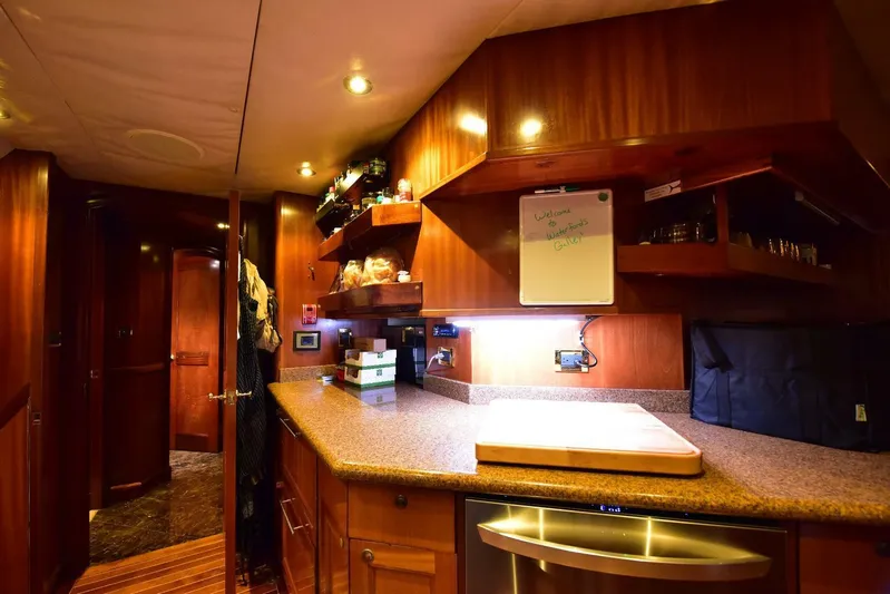 Waterford (name Reserved) Yacht Photos Pics Luxurious yacht kitchen interior with wooden cabinetry and modern appliances, 2016 Sovereign Pilothouse.