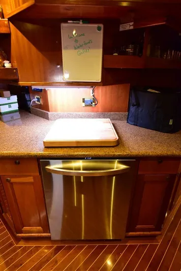 Waterford (name Reserved) Yacht Photos Pics Luxurious yacht kitchen with wooden cabinetry and stainless steel dishwasher, Sovereign 2016 model.