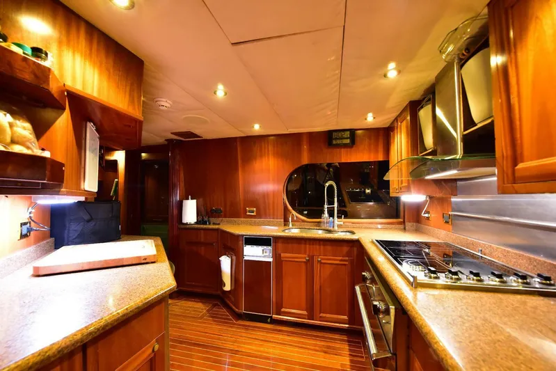 Waterford (name Reserved) Yacht Photos Pics Luxurious yacht kitchen with wooden cabinetry, modern appliances, and ambient lighting. Sovereign 2016 model.