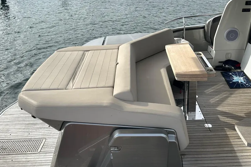  Yacht Photos Pics Luxurious 2018 Cranchi E52F yacht deck with beige seating and wooden table.