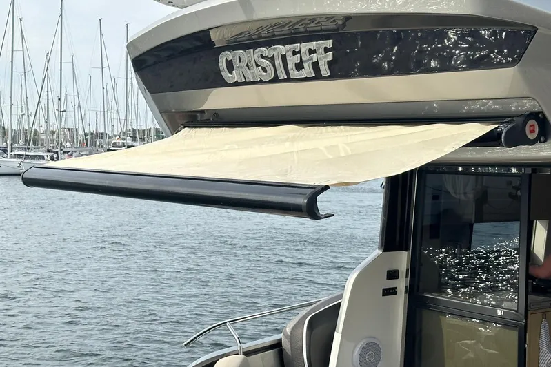  Yacht Photos Pics 2018 Cranchi E52F yacht with extended sunshade, docked in a marina.