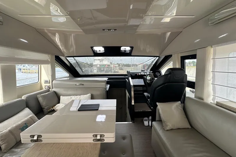  Yacht Photos Pics Luxurious interior of 2018 Cranchi E52F yacht with modern seating and helm.