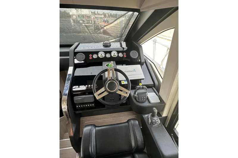  Yacht Photos Pics 2018 Cranchi E52F yacht helm with steering wheel and navigation controls.