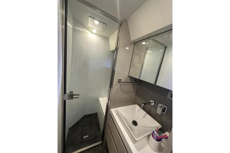  Yacht Photos Pics Modern bathroom in 2018 Cranchi E52F yacht with glass shower and sleek sink.
