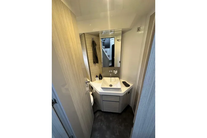  Yacht Photos Pics Modern bathroom interior on 2018 Cranchi E52F yacht, featuring sleek sink and mirror.