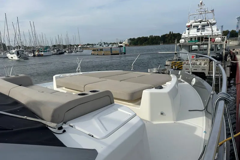  Yacht Photos Pics 2018 Cranchi E52F yacht docked at marina with spacious sunbathing area.