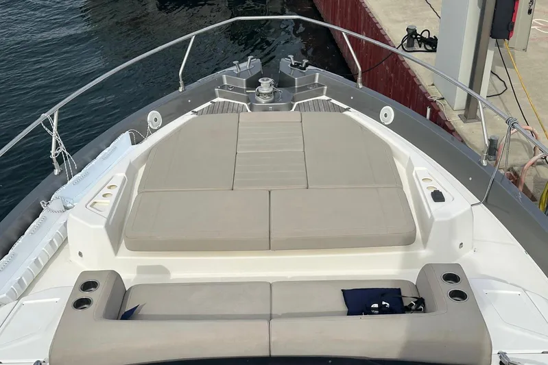  Yacht Photos Pics 2018 Cranchi E52F yacht bow with cushioned seating and cup holders, docked at marina.