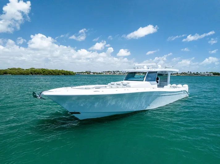  Yacht Photos Pics 2025 HCB 56' Sueños GIX luxury yacht cruising on clear blue water.