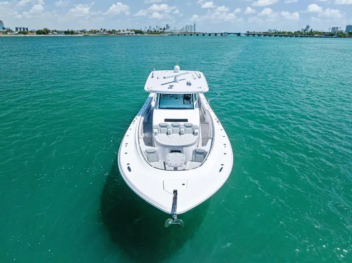  Yacht Photos Pics 2025 HCB 56' Sueños GIX yacht cruising on turquoise waters under a clear sky.